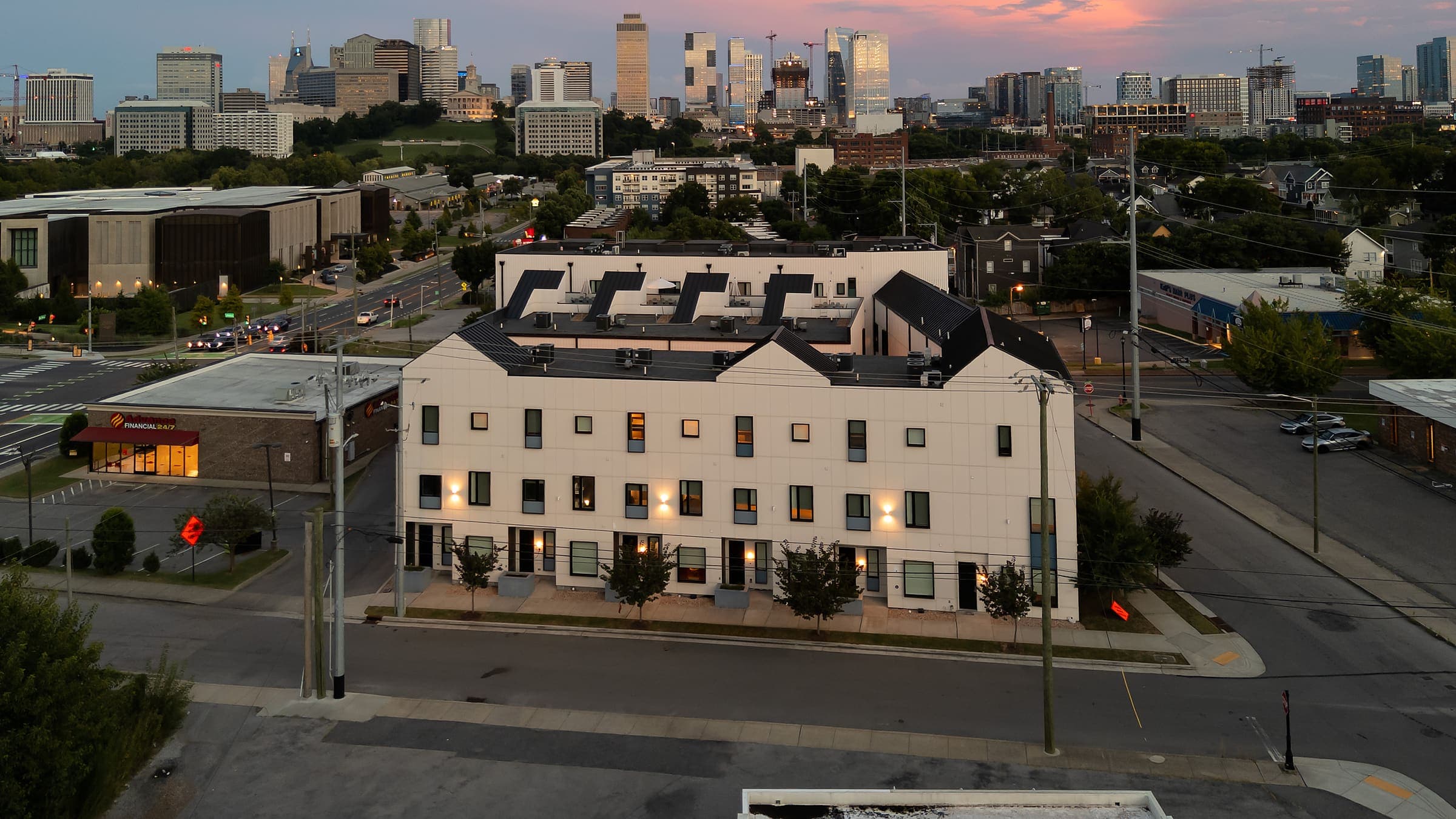 The Conway at twilight with the downtown Nashville skyline behind it