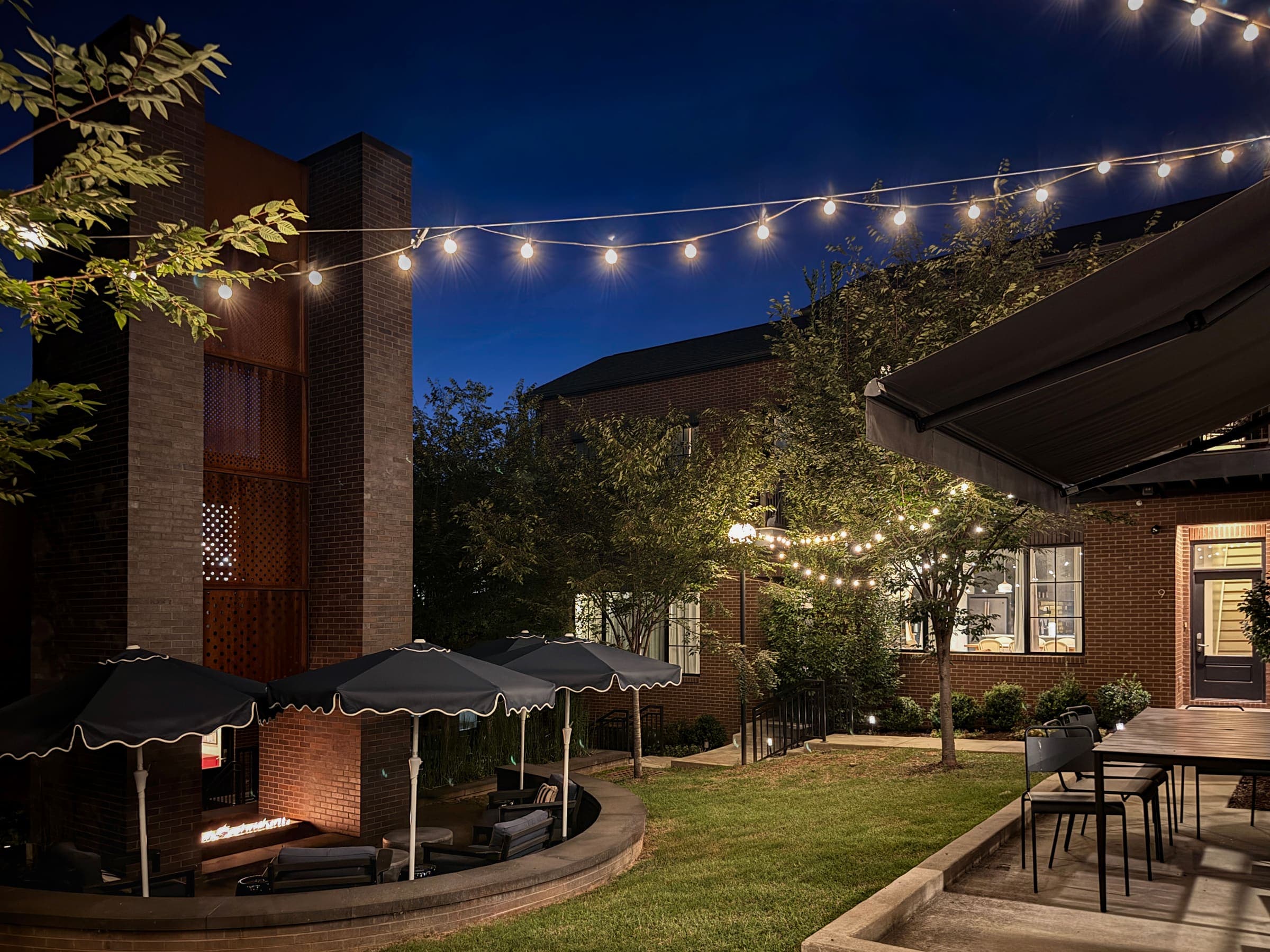 The Magnolia courtyard with its firepit lounge at twilight