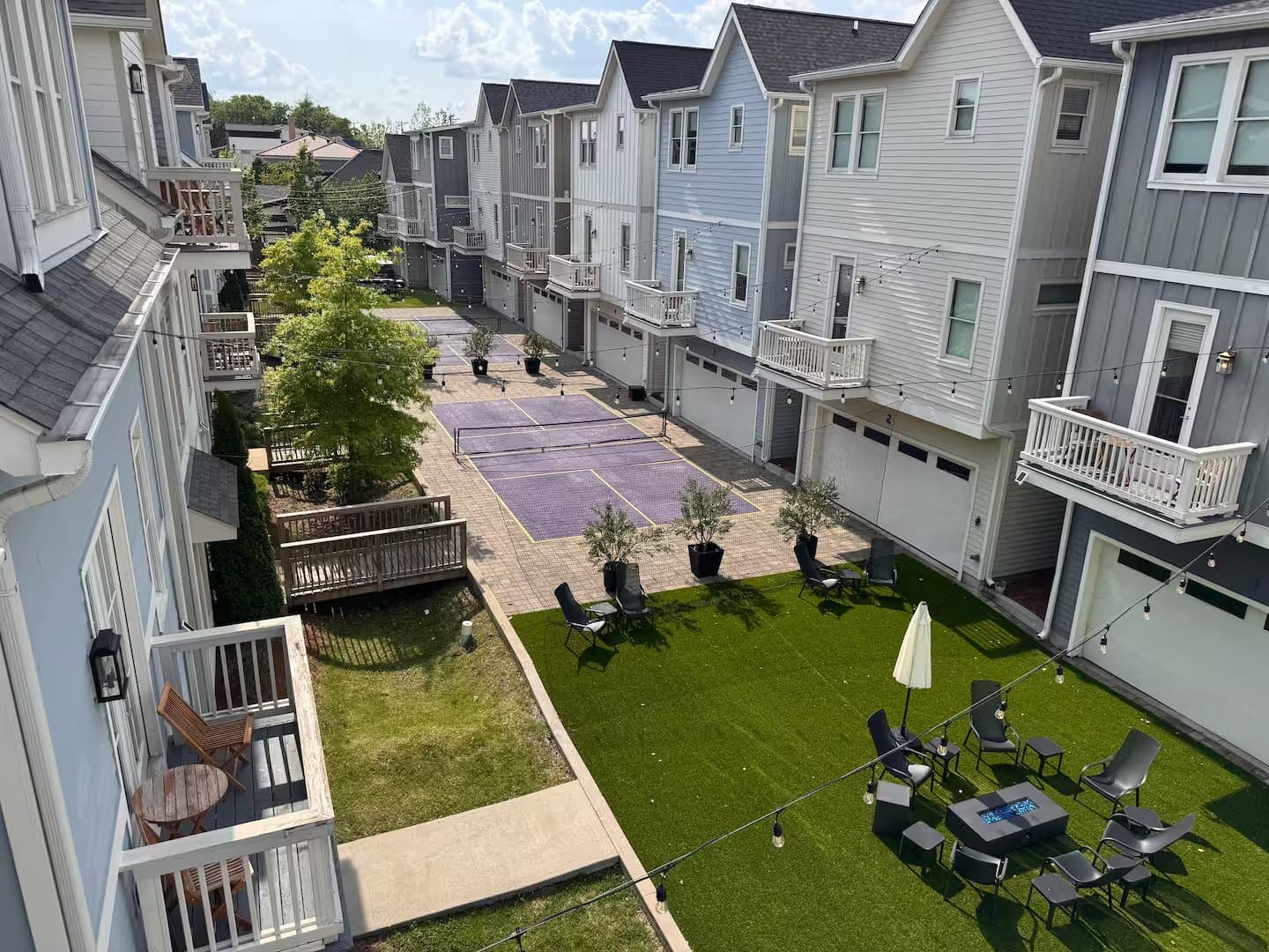 The Monroe's shared courtyard with lawn and pickleball court