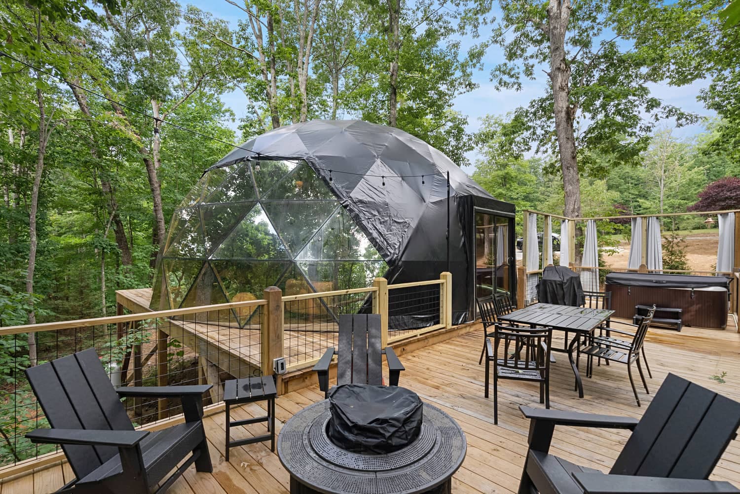 A Terralodge dome with its deck, hot tub and firepit